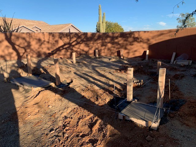 Arizona Creations Landscaping Worker Setting Concrete in backyard in Maricopa County AZ